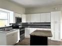 Updated kitchen with granite countertops and white cabinets at 1413 45Th St, Orlando, FL 32839
