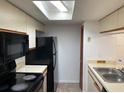 Kitchen with black appliances and double sink at 2717 N Poinciana Blvd # 179, Kissimmee, FL 34746