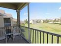 Screened balcony with patio furniture and view of grassy area at 2305 Silver Palm Dr # 302, Kissimmee, FL 34747