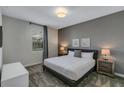 Spacious bedroom with a king-size bed and gray walls at 4514 Narrative Ln, Kissimmee, FL 34746