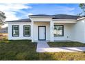 Contemporary single story home features a walkway to the front entrance at 1306 Congo Dr, Poinciana, FL 34759