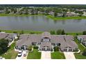 Condos near a lake with parking in front at 38 Lakepointe Cir, Kissimmee, FL 34743