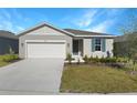 New single-story home with attached garage and landscaped front yard at 2035 Stetson Ct, Eagle Lake, FL 33839