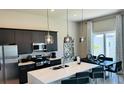 Modern kitchen with dark cabinetry and island at 7740 Sandy Ridge Dr # 226, Kissimmee, FL 34747