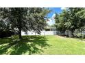 Large grassy backyard with a privacy fence and mature trees at 14642 Yellow Butterfly Rd, Windermere, FL 34786