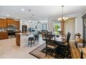 Open kitchen with island, dining area, and Gathering room access at 742 San Joaquin Rd, Poinciana, FL 34759