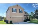 Two-story house with beige siding, brown shutters, and two-car garage at 108 Country Walk Cir, Davenport, FL 33837