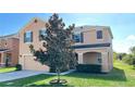 Two-story house with beige exterior and magnolia tree at 108 Country Walk Cir, Davenport, FL 33837