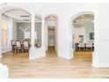 Elegant dining room with hardwood floors and arched entryways at 4962 Lazy Oaks Way, St Cloud, FL 34771