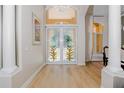 Bright entryway featuring double doors with pineapple-themed stained glass at 4962 Lazy Oaks Way, St Cloud, FL 34771