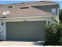 Attached garage with green door and house number at 2884 Grasmere View Pkwy, Kissimmee, FL 34746