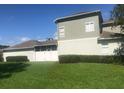 Back of house with grassy yard and privacy fence at 2884 Grasmere View Pkwy, Kissimmee, FL 34746