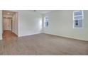 Bright and spacious living room with wood-look tile floors at 4244 Sawtooth Ct, Tavares, FL 32778
