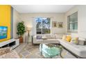 Living room with a sectional sofa and large window at 880 Pebble Beach Dr, Davenport, FL 33896