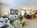 Bright and spacious living room and dining area with neutral decor at 1038 Orange Cosmos Blvd, Davenport, FL 33837
