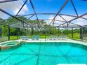 Inviting screened pool and spa with plenty of lounge chairs at 1038 Orange Cosmos Blvd, Davenport, FL 33837