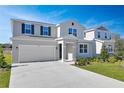 Two-story house with attached garage and landscaped lawn at 308 Alexandrite St, Deland, FL 32720