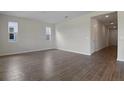 Spacious living room with wood-look tile flooring and neutral walls at 308 Alexandrite St, Deland, FL 32720
