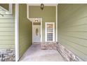 Front entrance with a light-colored door and stone accents at 607 Powell St, Wildwood, FL 34785