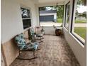 Relaxing screened porch with rocking chairs, perfect for enjoying the Florida weather at 2518 Bowmer Dr, Kissimmee, FL 34744