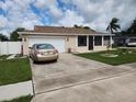 Single-story home with attached garage and spacious driveway at 2518 Bowmer Dr, Kissimmee, FL 34744