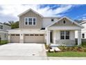 Two-story home with neutral siding and a three-car garage at 1416 Maddie Berry Ln, Kissimmee, FL 34744