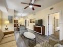 Open living area with hardwood floors, comfy seating, and views into dining and kitchen areas at 12544 Floridays Resort Dr # 202B, Orlando, FL 32821