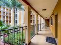 Inner hallway with lush courtyard views at 12538 Floridays Resort Dr # C-211, Orlando, FL 32821