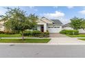 Craftsman style home with two-car garage and well-maintained lawn at 5012 E Fountainwood Dr, St Cloud, FL 34772