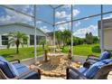 Relaxing screened patio with fountain and seating at 220 Lewis Dr, Davenport, FL 33837
