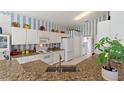 Bright kitchen with granite countertops and white cabinets at 220 Lewis Dr, Davenport, FL 33837