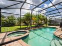 Enclosed pool and spa with lush landscaping at 305 Villa Sorrento Cir, Haines City, FL 33844