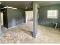 Spacious living room with dark gray walls and concrete floors at 316 Pennsylvania Ave, Saint Cloud, FL 34769
