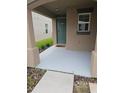 A small front porch with a teal door and freshly painted floor at 1629 Yellow Trl, Lakeland, FL 33801