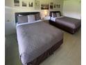 Spacious bedroom with two queen beds and wall art at 5245 W Irlo Bronson Memorial Hwy # 234, Kissimmee, FL 34746
