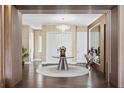 Elegant entryway with modern chandelier and wood floors at 15620 Panther Lake Dr, Winter Garden, FL 34787