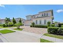 Two-story house with a three car garage and landscaping at 15620 Panther Lake Dr, Winter Garden, FL 34787