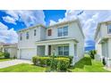 Two-story house with a two-car garage and landscaped yard at 2378 White Lilly Dr, Kissimmee, FL 34747