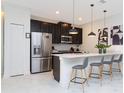 Modern kitchen with stainless steel appliances and an island at 1038 Splash Shot Pl, Davenport, FL 33896