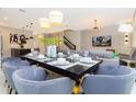 Modern dining room with a large table and seating for six at 1038 Splash Shot Pl, Davenport, FL 33896