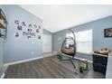 Living room with hanging chair and view into the dining area at 104 Langham Dr, Davenport, FL 33897