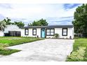 Charming house with modern exterior and a freshly landscaped yard at 1411 Overdale St, Orlando, FL 32825