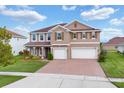 Two-story home with a charming exterior and a two-car garage at 4957 Whistling Wind Ave, Kissimmee, FL 34758