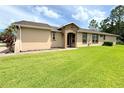 Back exterior view of house, landscaped backyard at 790 Shady Canyon Way, Poinciana, FL 34759