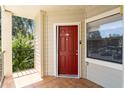 Condo entry with red door and small balcony at 3032 Parkway Blvd # 201, Kissimmee, FL 34747