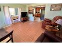 Bright living room with tiled floors and a view into the kitchen at 1206 Osceola Ave, Tavares, FL 32778