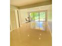 Bright living room with tile floors, sliding glass doors, and exercise bike at 5341 Indian Creek Dr # B, Orlando, FL 32811