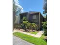 Dark brown two-story condo with wood siding and a small fenced yard at 5341 Indian Creek Dr # B, Orlando, FL 32811