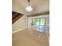 Bright living room with tile floors, sliding glass doors, and exercise bike at 5341 Indian Creek Dr # B, Orlando, FL 32811