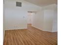 Open living room with light wood floors and neutral walls at 1025 W Lake Hamilton Dr, Winter Haven, FL 33881